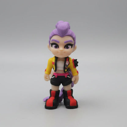Front view of a 3D printed Rumi figure from Kpop Demon Hunters with purple hair in a high bun, a confident expression, a yellow jacket, black shorts, and red and black boots, displayed on a neutral background.