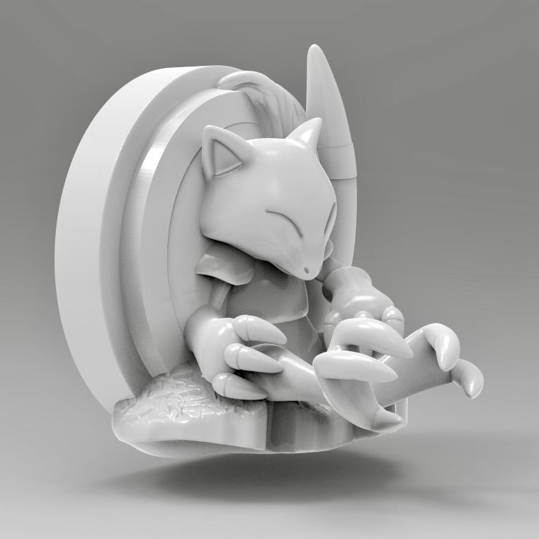 3D printed Abra wall art shown at an angled view, with Abra peacefully sleeping while leaning against its card frame.