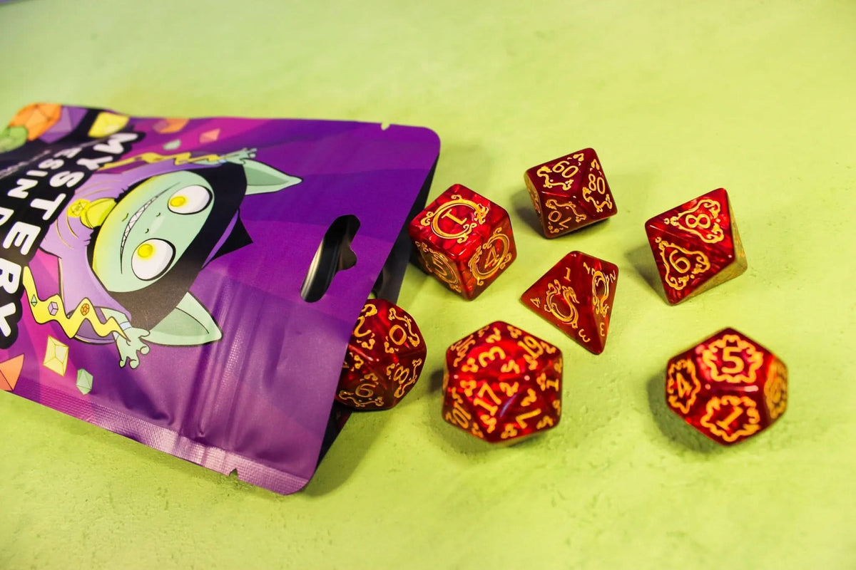 Set of red dice with orange patterns on a green surface coming out of a purple mystery bag with a goblin on it.