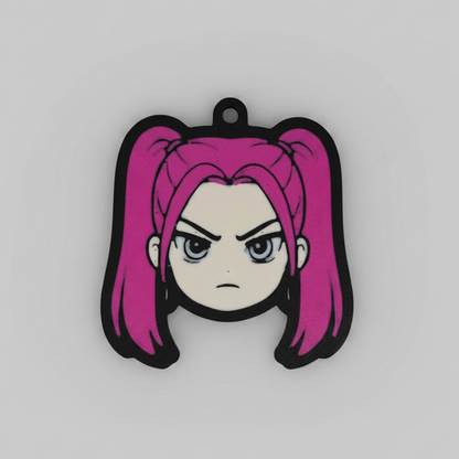 3D printed keychain of Mira from K-Pop Demon Hunter, featuring her signature hot pink twin pigtails, intense grey-blue eyes, and a fierce frowning expression that captures her fiery personality.