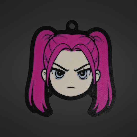 3D printed keychain of Mira from K-Pop Demon Hunter, featuring her signature hot pink twin pigtails, intense grey-blue eyes, and a fierce frowning expression that captures her fiery personality.