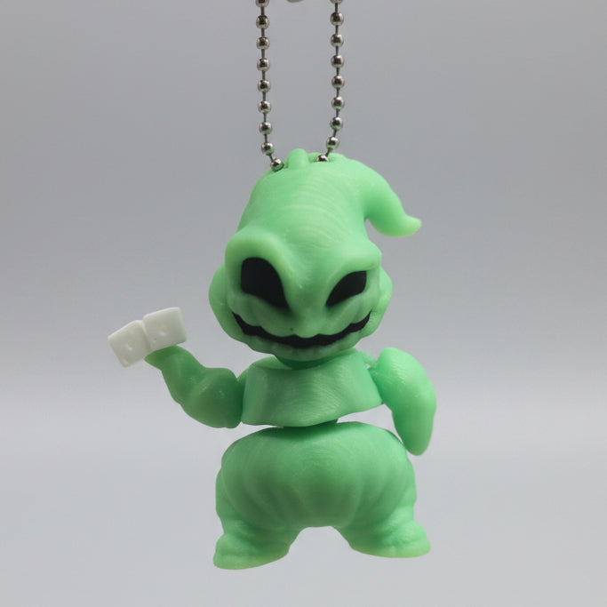Glow-in-the-dark Oogie Boogie Flexi Friend keychain with silver ball chain, held in a hand to show its portable size.