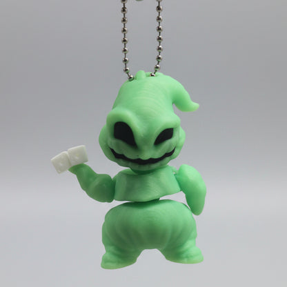 Glow-in-the-dark Oogie Boogie Flexi Friend keychain with silver ball chain, held in a hand to show its portable size.