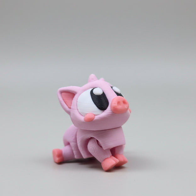Side view of a pink 3D printed pig figurine showing chunky legs and pastel details