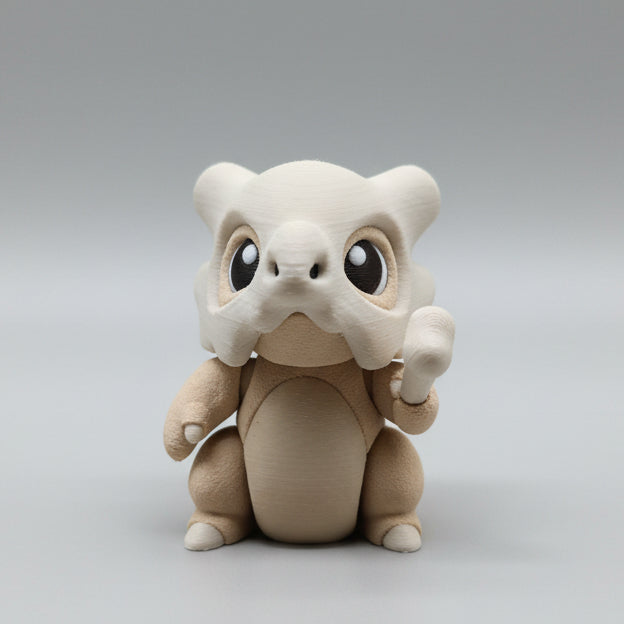 Front view of a 3D printed Cubone flexi toy with oversized expressive eyes, skull mask helmet, and bone accessory, designed with articulated joints for gentle fidgeting