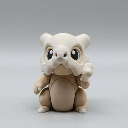 Front view of a 3D printed Cubone flexi toy with oversized expressive eyes, skull mask helmet, and bone accessory, designed with articulated joints for gentle fidgeting