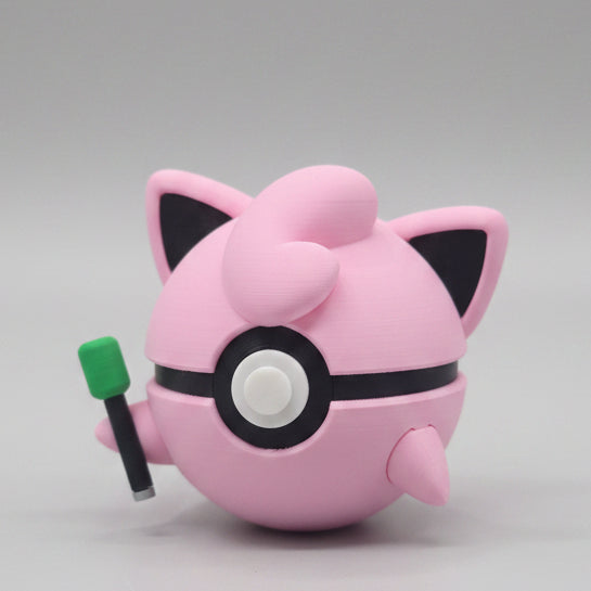 Side view of Jigglypuff inspired Pokéball 3D print showing pink colouring, pointed ears, swirl hair detail, and microphone accessory.