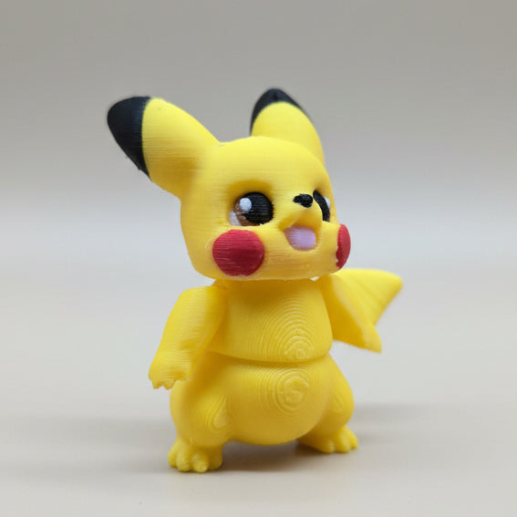Angled front view of articulated Pikachu 3D printed figure featuring red cheeks, rounded body, and raised arm detail