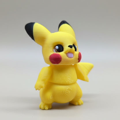 Angled front view of articulated Pikachu 3D printed figure featuring red cheeks, rounded body, and raised arm detail