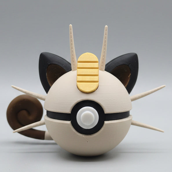 A 3D printed Meowth inspired Pokéball collectible featuring cream colouring, black cat-like ears, long whiskers, a curled tail, and Meowth’s signature gold charm detail on top. A fun Pokémon themed display piece for collectors, gamers and fans.
