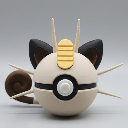 A 3D printed Meowth inspired Pokéball collectible featuring cream colouring, black cat-like ears, long whiskers, a curled tail, and Meowth’s signature gold charm detail on top. A fun Pokémon themed display piece for collectors, gamers and fans.