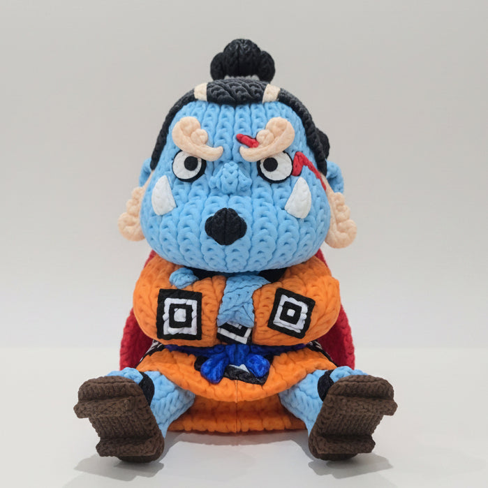 3D printed knitted-style Jinbe figure inspired by One Piece, featuring blue skin, an orange outfit, black hair and red cape.