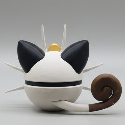Cat-shaped Meowth pokeball with black ears, brown tail, and gold top on a gray background