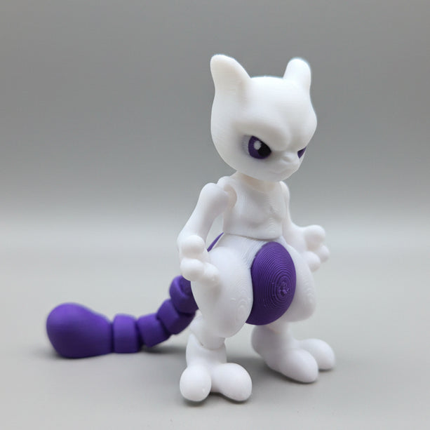 Side angle of a Mewtwo flexi figure showing articulated tail and stance