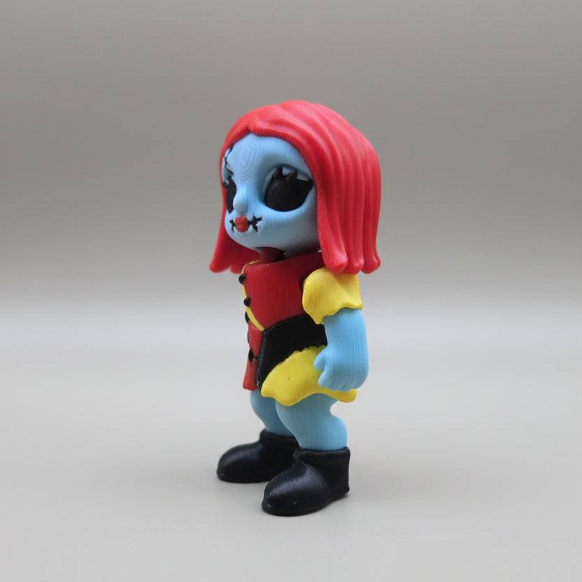 Alternate side angle of a Sally flexi figure showing stitched face and outfit
