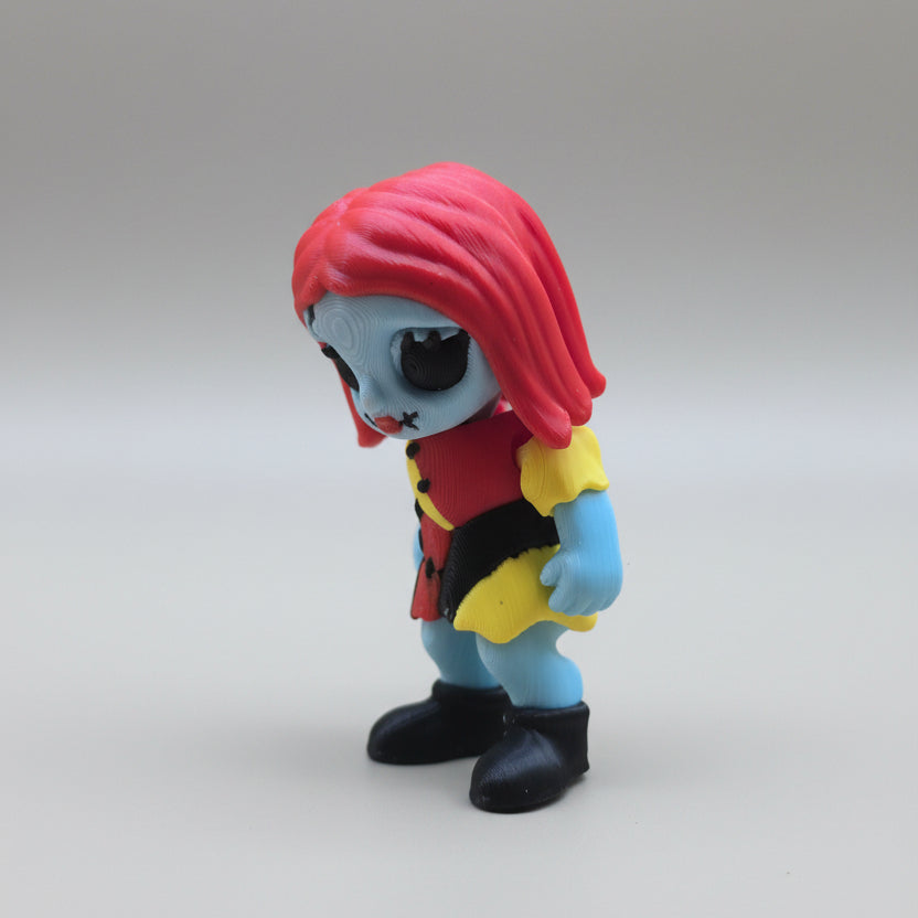 Side view of a Sally 3D printed flexi figure with red hair and black boots
