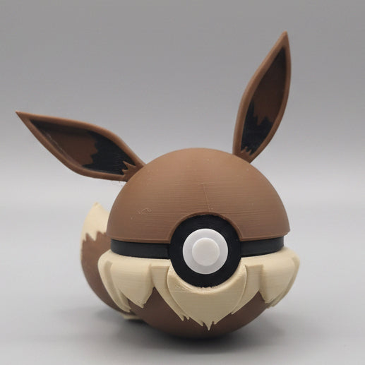 Eevee inspired 3D printed Pokéball collectible featuring brown colouring, fluffy cream details, large ears, and adorable Eeveelution themed design for Pokémon fans and collectors.