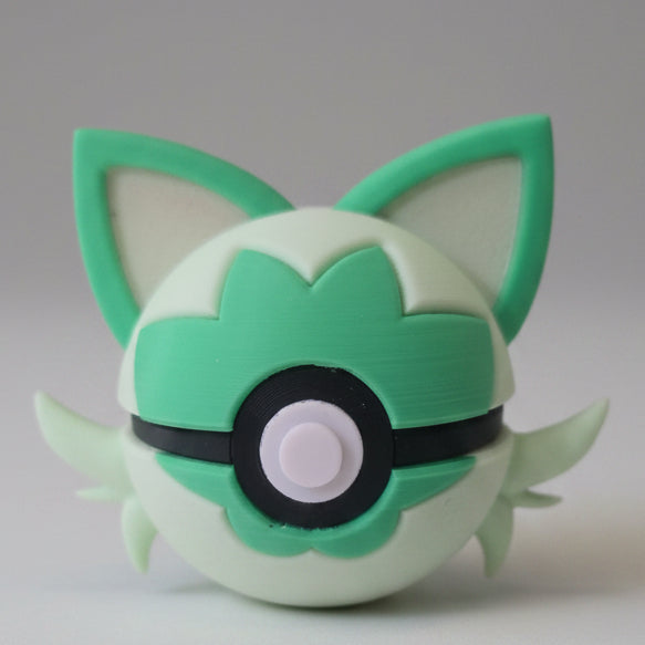 Front view of Sprigatito inspired Pokéball 3D print showing large green ears, leaf shaped markings, and cute feline features.