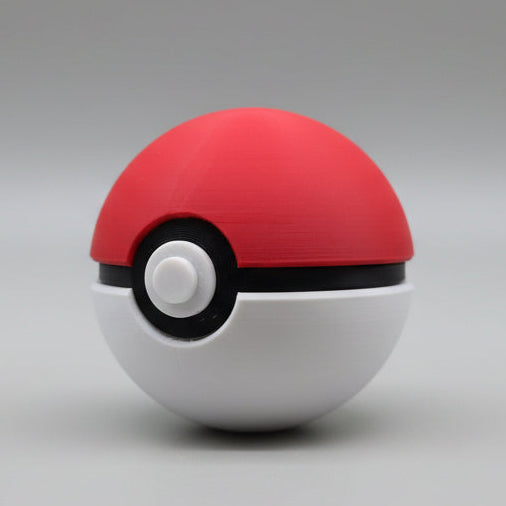 Angled side view of a 3D printed Pokéball showing the red dome, black band detail, and circular white button.