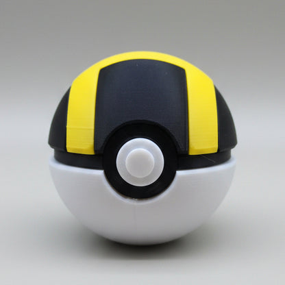 3D printed Ultra Ball with black top and bold yellow stripes, white base and central button, shown against a plain light background.