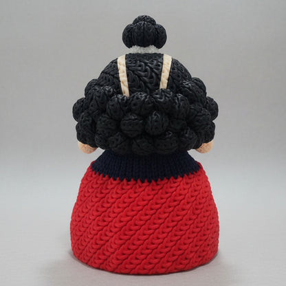 Back view of a 3D printed knitted-style Jinbe figure showing his textured black hair and large red cape