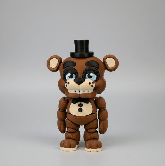Front view of a 3D printed Freddy Fazbear flexi figure inspired by Five Nights at Freddy’s, featuring a brown animatronic bear with articulated limbs, black top hat, bow tie, blue eyes, button details, and a toothy grin, photographed against a clean light background.