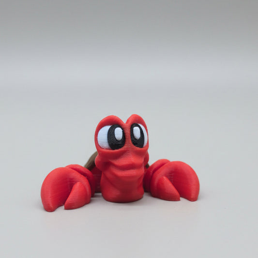 Red 3D printed Sebastian crab flexi figure facing forward on a light background
