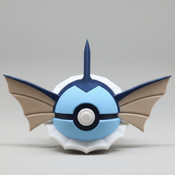 3D printed Vaporeon inspired Pokéball collectible featuring blue colouring, fin shaped ears, a head crest, white neck frill details and classic Pokéball button design. A cute Pokémon themed display piece photographed on a grey background.