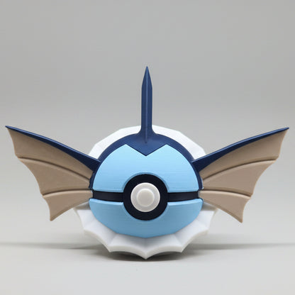 3D printed Vaporeon inspired Pokéball collectible featuring blue colouring, fin shaped ears, a head crest, white neck frill details and classic Pokéball button design. A cute Pokémon themed display piece photographed on a grey background.