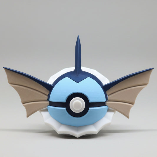 3D printed Vaporeon inspired Pokéball collectible featuring blue colouring, fin shaped ears, a head crest, white neck frill details and classic Pokéball button design. A cute Pokémon themed display piece photographed on a grey background.